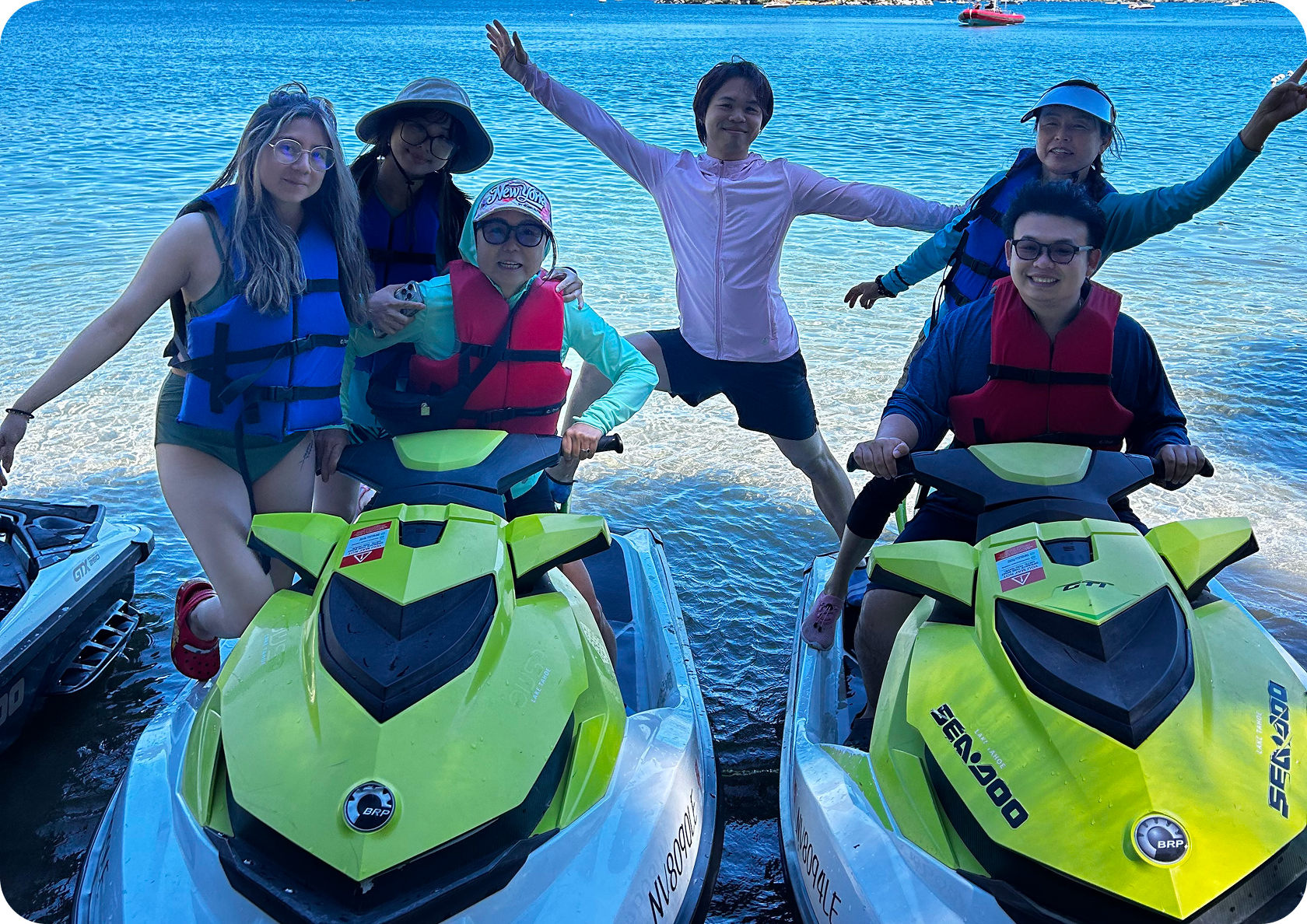 Group enjoying jet skis by the water.