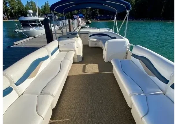 Pontoon boat docked on a sunny day.